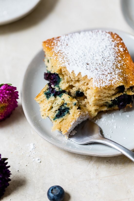 A slice of Blueberry Buttermilk Cake on a plate.