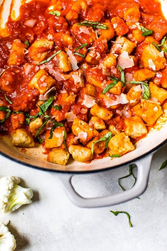 Cauliflower Gnocchi in a pot with marinara sauce.