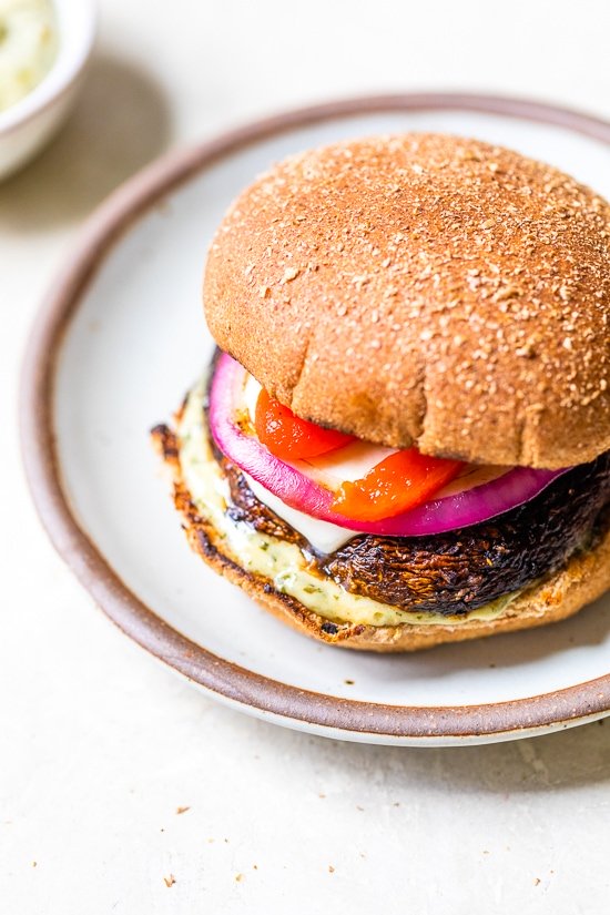 These grilled Portobello Mushroom Burgers topped with mozzarella, red peppers, and pesto mayo, are delicious and an excellent vegetarian burger option.