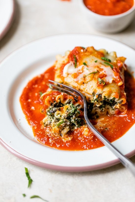 Mushroom Kale Lasagna Rolls with a fork.